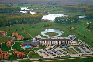 an aerial view of a resort with a parking lot at Birdland Panorama Apartman in Bük