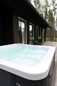 a hot tub on the deck of a house at Economy Autto in Levi