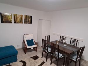 a dining room with a table and chairs at Sünfészek Vendégház in Göd