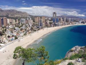 a view of a beach with buildings and the ocean at Luxury apartment Residencial Sunset Drive - Benidorm, España in Benidorm