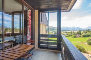 a porch with a bench and a view of the mountains at Le Balcon d'Ancelle - Appt vue montagne in Ancelle