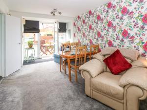 a living room with a couch and a table at Sea View Cottage in South Shields