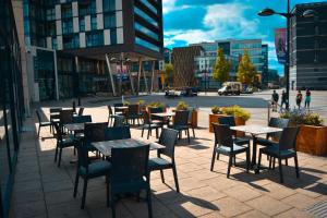 a group of tables and chairs on a city street at Holiday Inn Express Leeds City Centre - Armouries, an IHG Hotel in Leeds