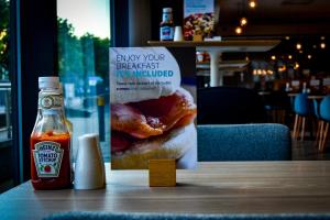 a sign on a table with a sandwich and a bottle of ketchup at Holiday Inn Express Leeds City Centre - Armouries, an IHG Hotel in Leeds