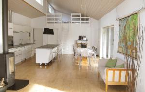 a kitchen and living room with a table and a couch at 3 Bedroom Gorgeous Home In Rnde in Dagstrup