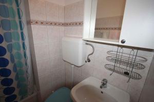 a small bathroom with a sink and a toilet at Apartment in Silo/Insel Krk 14533 in Šilo