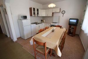 a kitchen with a table and chairs in a room at Apartment in Silo/Insel Krk 14533 in Šilo