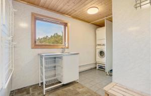 a laundry room with a sink and a window at Nice Home In Valevg With Sauna And 2 Bedrooms in Valevåg