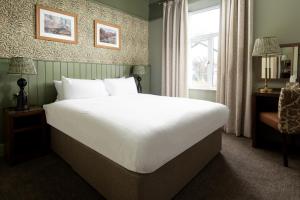 a bedroom with a large white bed and a window at The Lakehouse Rooms at The Waterhead Inn, Ambleside in Ambleside +38 photos
