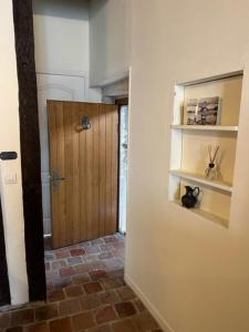 a hallway with a door and a brick floor at Appartement Meneau in La Charité-sur-Loire