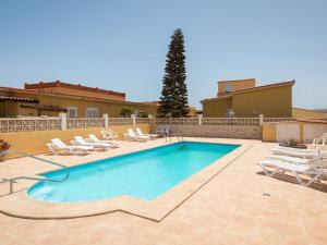 a swimming pool with lounge chairs and a house at Casa Marcelo, charming and renovated house in Antigua