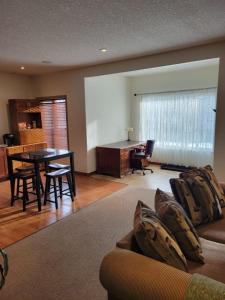 a living room with a couch and a table at Cochrane’s Finest Airbnb in Cochrane