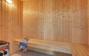 a sauna with a wooden floor and a wooden tub at Cozy Home In Frederiksværk With Sauna in Asserbo +23 photos