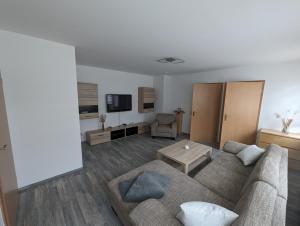 a living room with a couch and a table at FEWO An der Bode in Thale