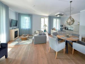 a living room with a table and a couch at FIRST Sellin - Appt 22 "Baltic Sea" mit seitlichem Meerblick in Ostseebad Sellin