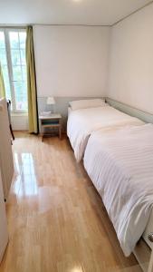 1 Schlafzimmer mit 2 Betten und einem Beistelltisch in der Unterkunft Nydeck in Bern