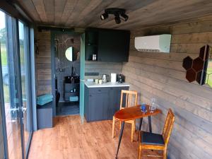 a kitchen and dining room with a table and chairs at Wild Meadow 