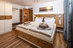 een slaapkamer met een groot bed en handdoeken bij Haus Bergwelten in Bischofswiesen