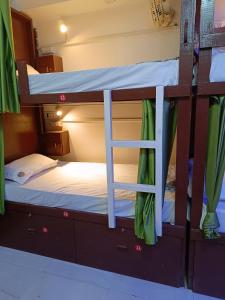 two bunk beds with a ladder in a room at Frazyone hostel in New Delhi