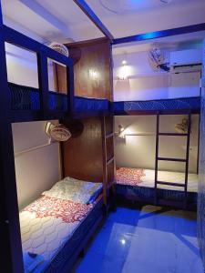 a bedroom with two bunk beds in a room at Frazyone hostel in New Delhi