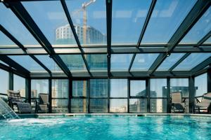 a swimming pool with a view of the city at Hotel Prishtina in Prishtinë