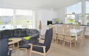 a living room and kitchen with a couch and a table at 3 Bedroom Amazing Home In Frederikshavn in Frederikshavn