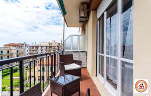 a balcony with chairs and a view of a city at Gioiello Marino - mare, 2 minuti a piedi in Pietra Ligure