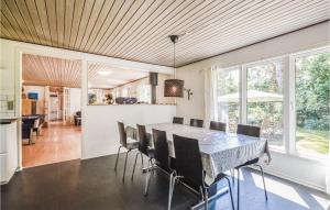 a kitchen and dining room with a table and chairs at Beautiful Home In Vig With 4 Bedrooms, Sauna And Wifi in Vig