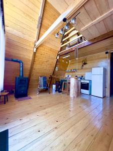 a large room with wooden walls and a wooden floor at A-frame mestia in Mestia