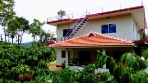 uma casa branca com um telhado laranja em Nithin homestay, private 3bedrooms house,madikeri em Madikeri