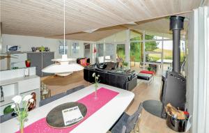 a kitchen and living room with a table and chairs at Pet Friendly Home In Knebel With Wifi in Knebel