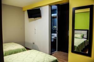 Postel nebo postele na pokoji v ubytování Plaza Sur Hotel & Suites
