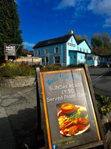 a sign on the side of a street with a building at Belle Vue Hotel in Llanwrtyd Wells