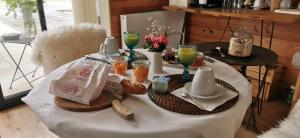 a table with food and drinks on top of it at La Santon Chambres d'hôtes in Vif