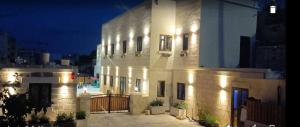 a white building with lights on the side of it at Ta' Gingel Farm Agriturisim B&B. Malta in St Paul's Bay