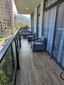 a balcony with chairs and tables on a building at Villa Paradise in Gonio