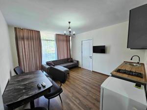 a living room with a couch and a table at Villa Paradise in Gonio