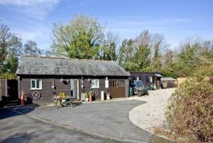 a log cabin with a picnic table in front of it at Hill Head Cottage in Saint Columb Major