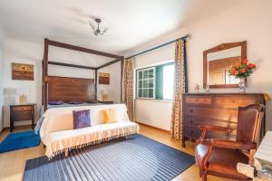 a bedroom with a bed and a dresser and a desk at Akivillas Sintra Delicacy in Sintra +32 photos