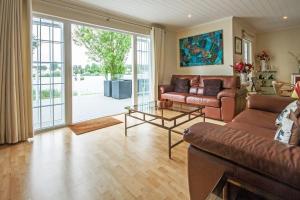 a living room with a couch and a table at Windrush Lake 65, Sunset Lodge - P in South Cerney