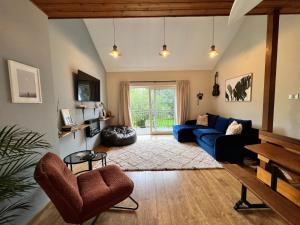 a living room with a blue couch and a table at Stylish Getaway in Y Felinheli Marina in Y Felinheli