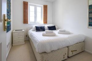 a bedroom with a large bed with two pillows on it at Windrush Lake 65, Sunset Lodge - P in South Cerney