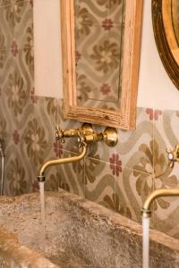 a bathroom sink with a mirror on a wall at Ca la Merce Batista in Palau-Saverdera