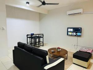 a living room with a couch and a table at Macagawa Homestay in Tawau