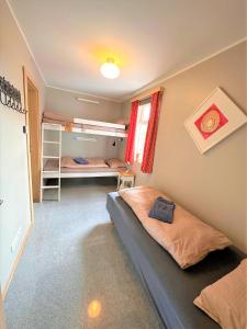 a bedroom with two bunk beds and a window at Beautiful lakehouse by the golden circle - fishing in Selfoss