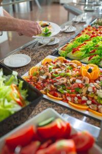 a buffet with many plates of food on a table at AR Roca Esmeralda & SPA Hotel in Calpe