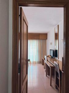 an open door to a room with a table and chairs at AR Roca Esmeralda & SPA Hotel in Calpe