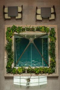 a building with a window with plants on it at AR Roca Esmeralda & SPA Hotel in Calpe