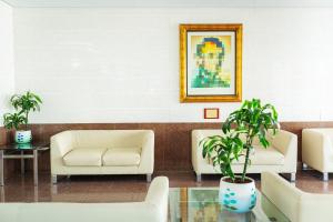 a waiting room with two white chairs and a painting at AR Roca Esmeralda & SPA Hotel in Calpe