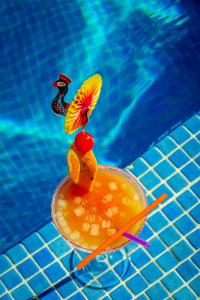 a drink in a bowl next to a swimming pool at AR Roca Esmeralda & SPA Hotel in Calpe